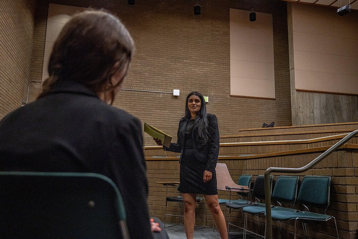 student practicing for mock trial in lecture hall