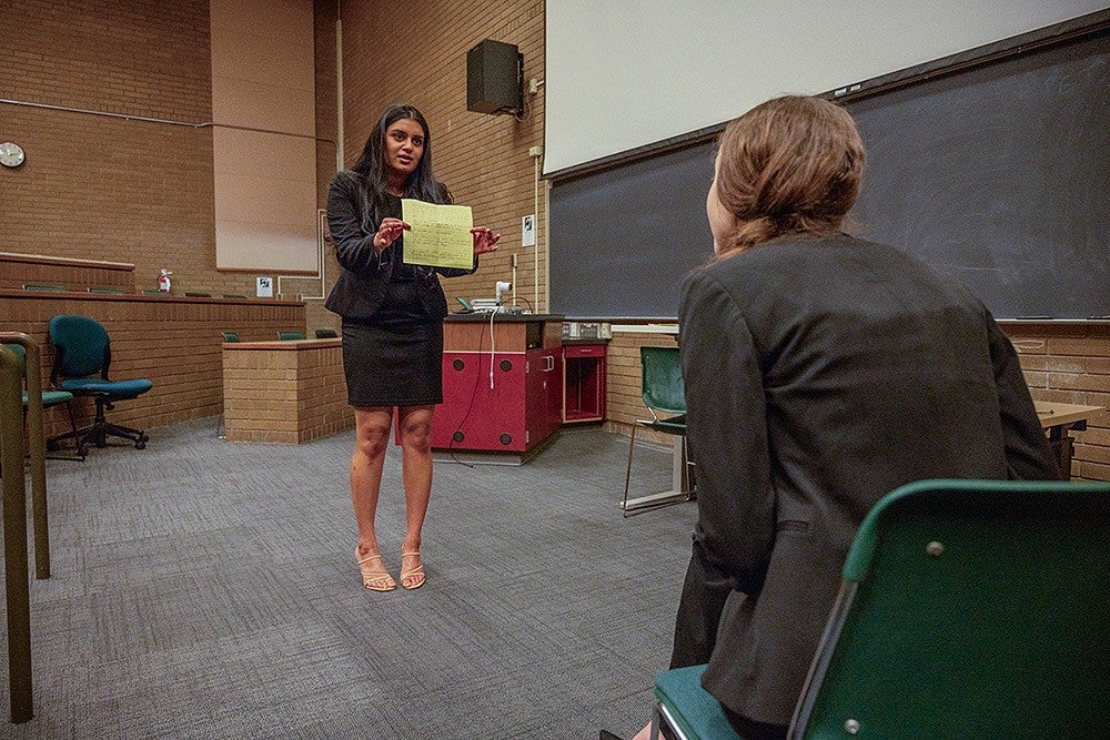 student practicing for mock trial in lecture hall