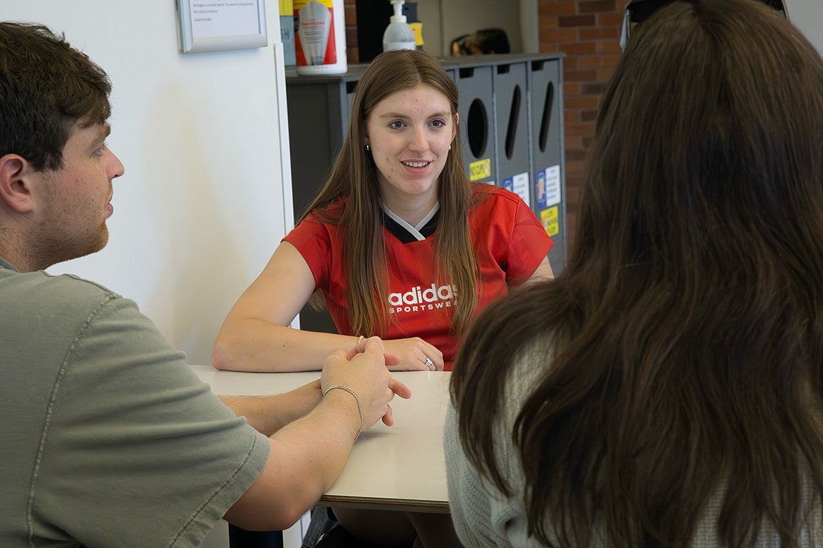 students talking around table