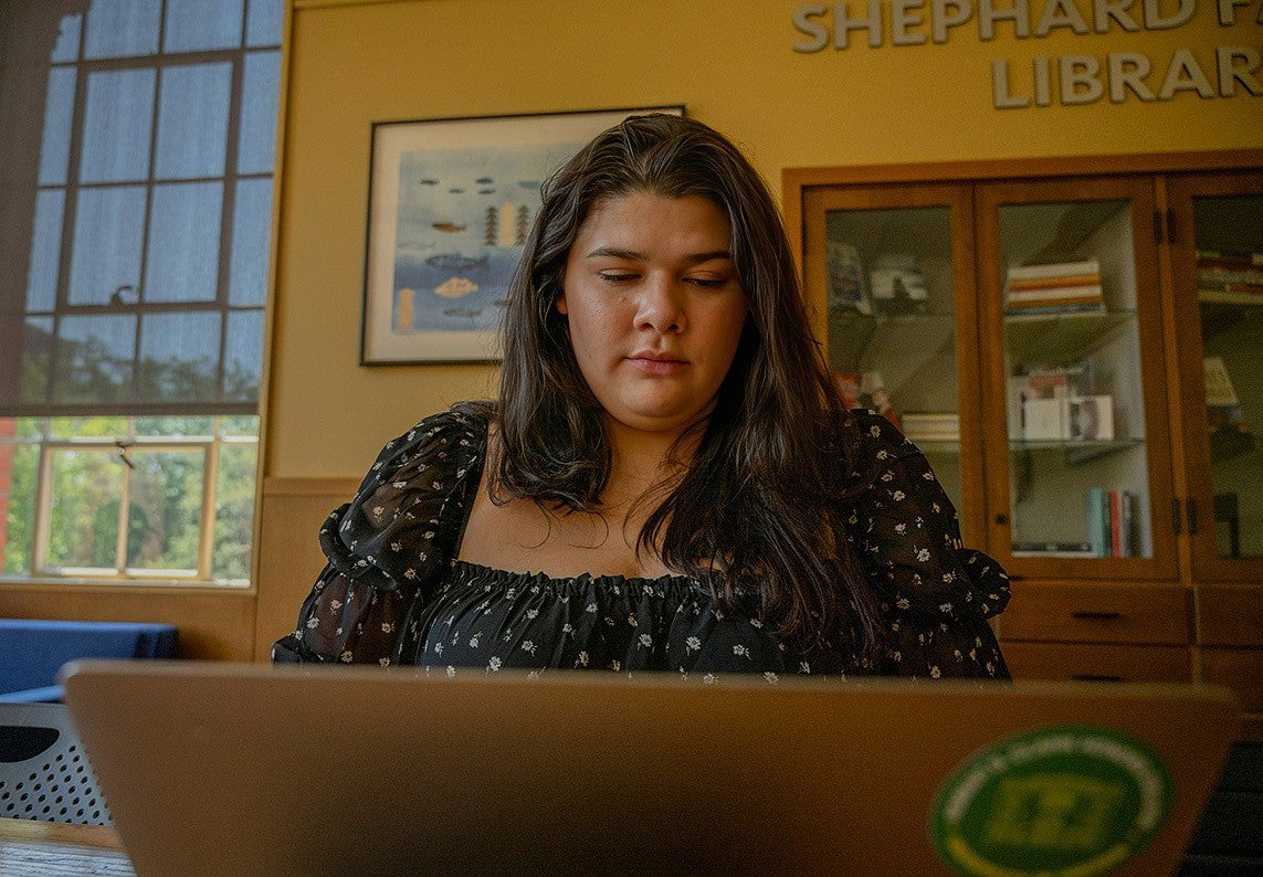 student on laptop in chapman library