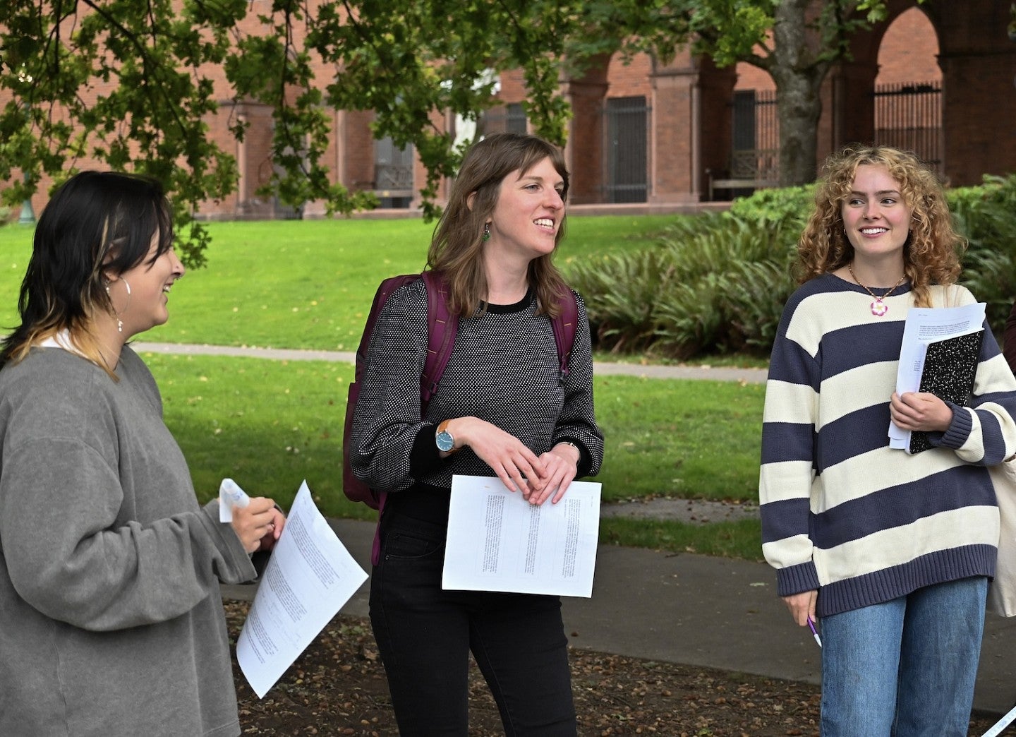 Kristen Rahilly teaching outside, standing among students