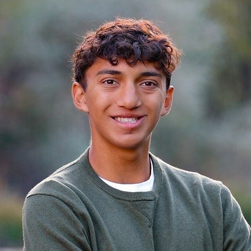 portrait of Marcus Grimaldo outside with blurred background