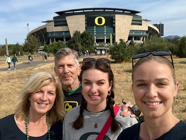 family photo in front of autzen stadium
