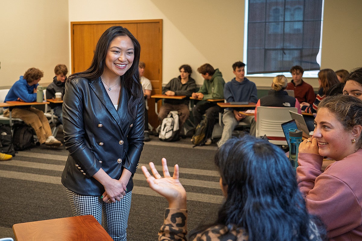 lorie acio smiles as she talks to a class in chapman hall