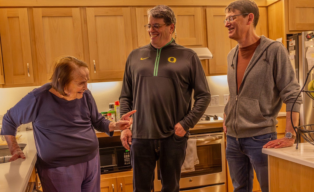 fred poust with his mother joy and brother alex in a kitchen