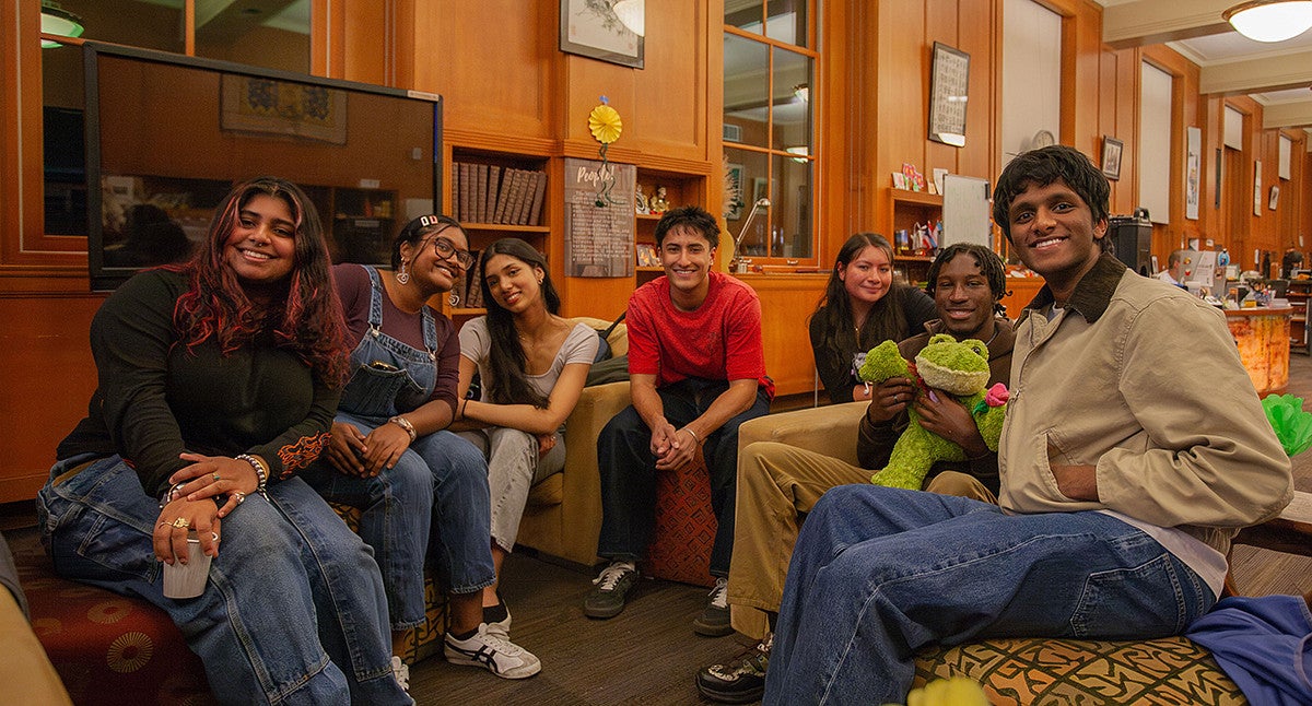 group of students smiling at camera in mills international center