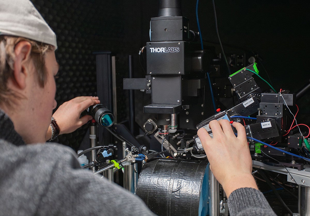 student working with large piece of science equipment