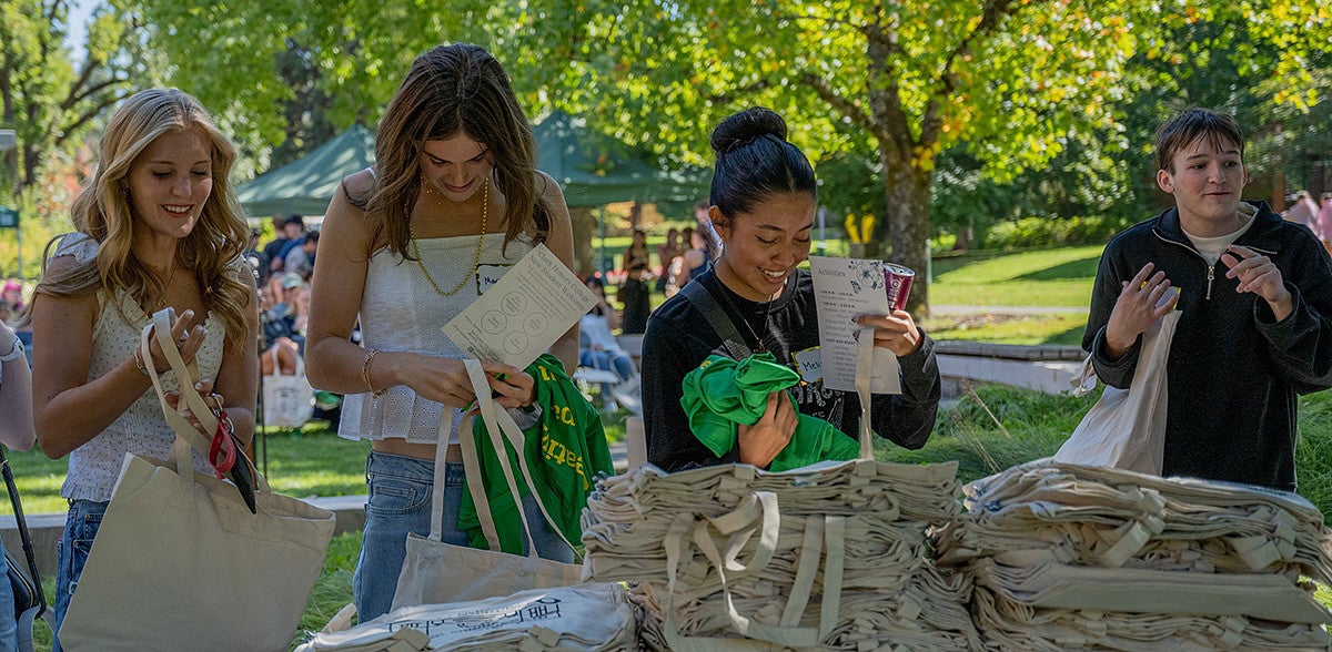 new chc students picking up tote bags at welcome event