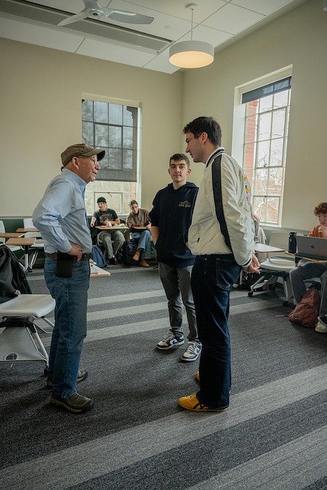 peter defazio talking with students in a classroom in chapman hall