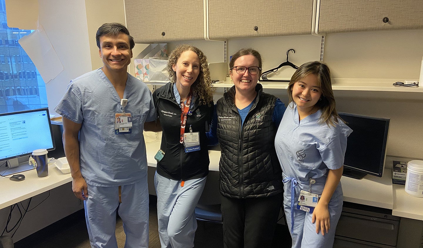 group of people in medical scrubs in an exam room or medical office