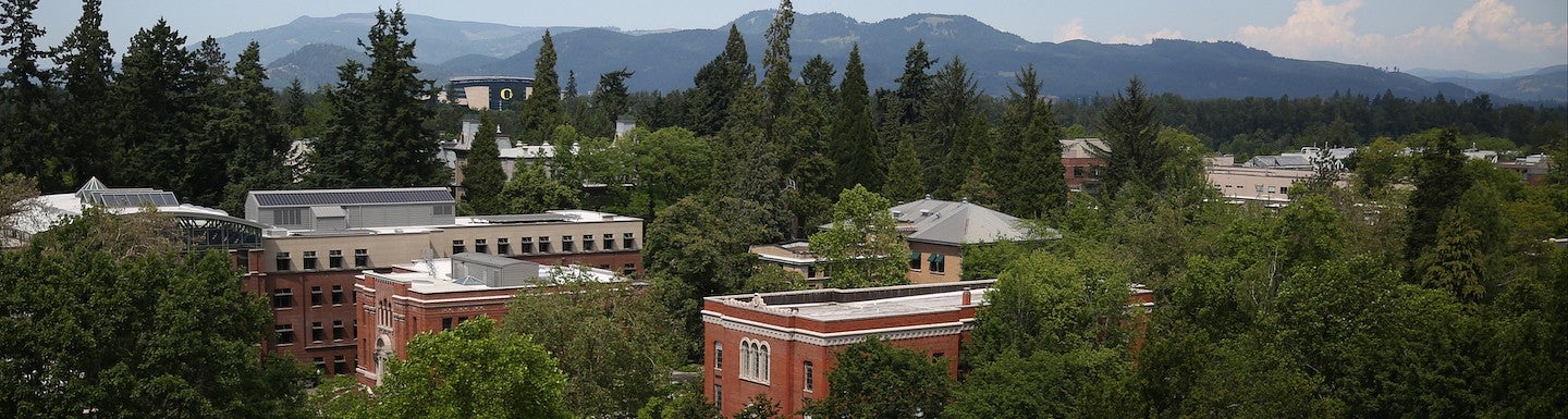 aerial view of campus with chapman hall in foreground and mountains in background