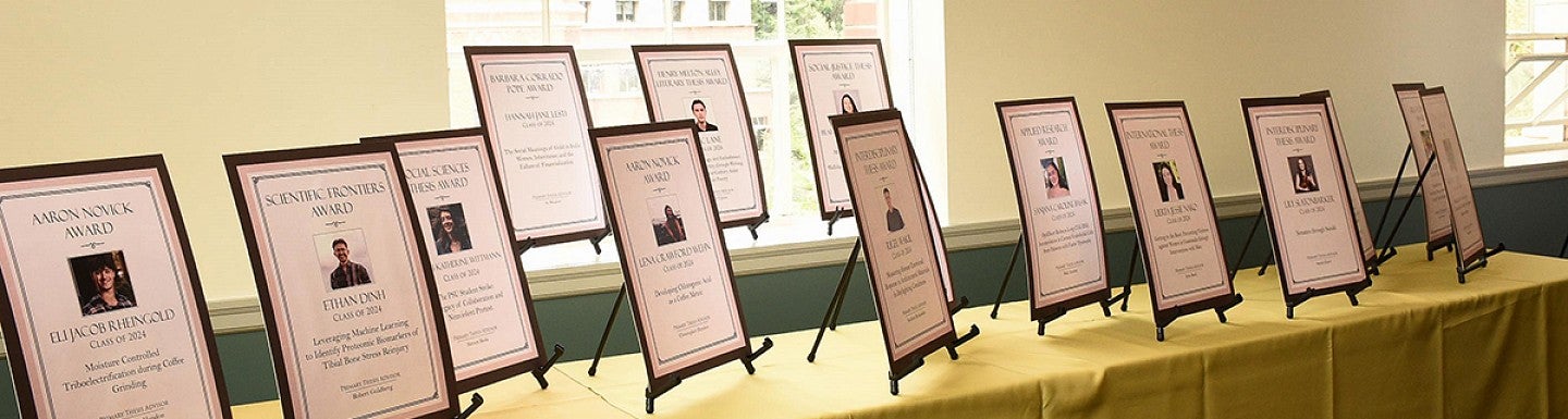 CHC thesis awards laid out on a long table in chapman hall