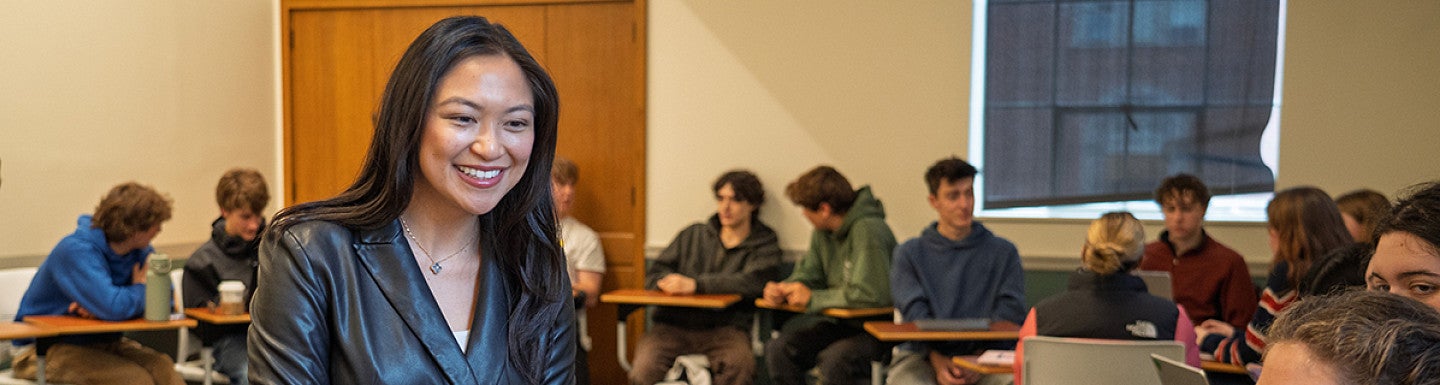 lorie acio smiles as she talks to a class in chapman hall
