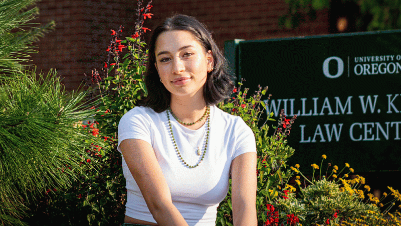 Kali deSaint Phale sitting in front of the William W Knight Law Center