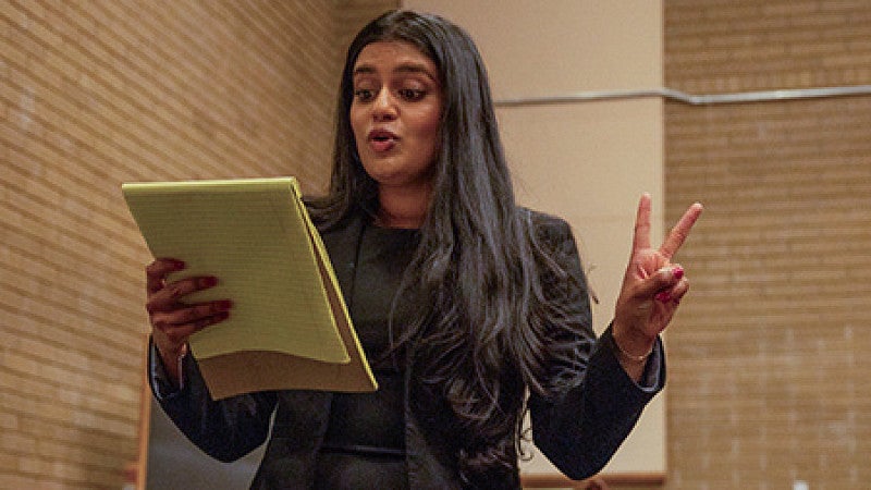 student arguing for mock trial holding legal pad
