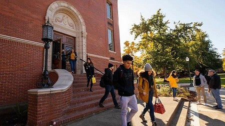 students walking down the brick steps of the west end of Chapman Hall.