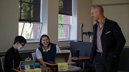 tobin hansen teaching in a classroom with students laughing at desks