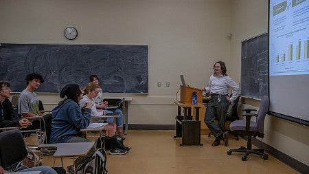 student presenting powerpoint to classroom