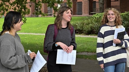 Kristen Rahilly teaching outside, standing among students