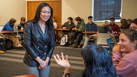 lorie acio smiles as she talks to a class in chapman hall
