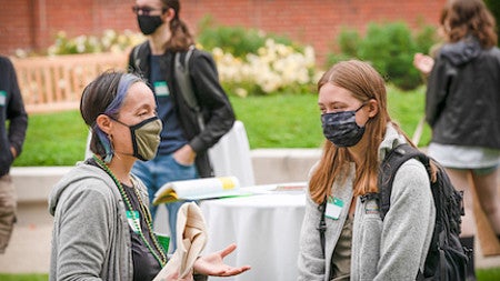 Professor Lisa Munger chats with a student. 