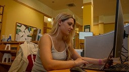 student working in cubicle