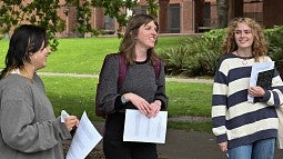 Kristen Rahilly teaching outside, standing among students