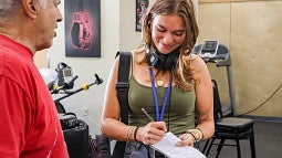 julia boboc reporting a story with audio gear and a notepad