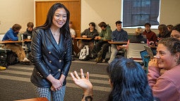 lorie acio smiles as she talks to a class in chapman hall