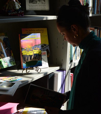 Profile image of Catalina de Onís standing at a desk and bookshelf