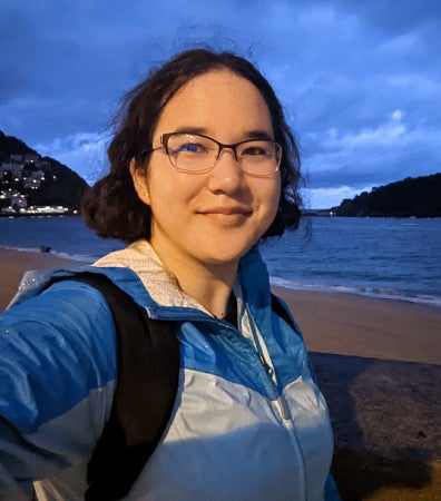 Emma Koontz on a beach at twilight.