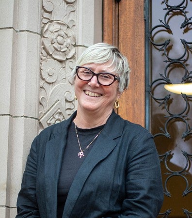 portrait of Carol Stabile in front of Chapman Hall doors