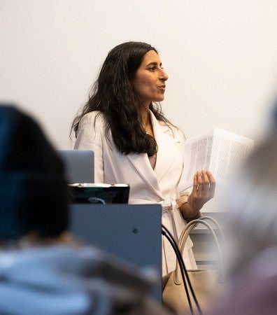 Anita Chari teaching at front of classroom