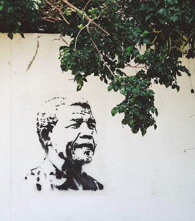 A portrait of Nelson Mandela stenciled on a wall 
