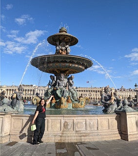 Emma Koontz standing in front of a large fountain.