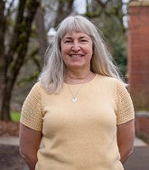 Lisa Wolverton standing outside Chapman Hall on an early spring day.