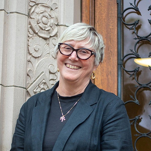 portrait of Carol Stabile in front of Chapman Hall doors