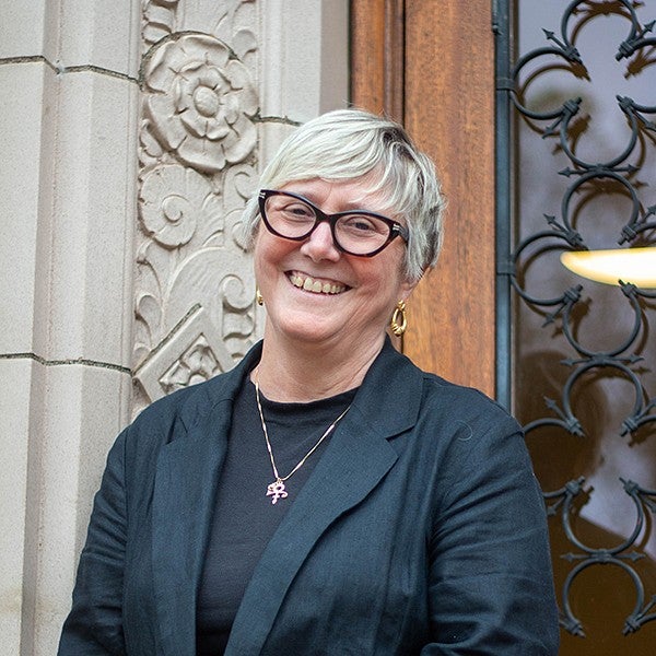 portrait of Carol Stabile in front of Chapman Hall doors