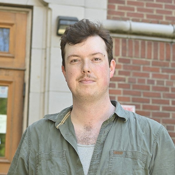 portrait of dominic adams on the steps of chapman hall