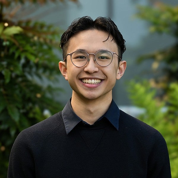 portrait of ethan dinh with leafy background