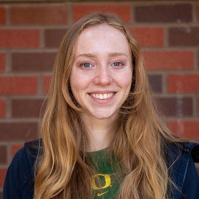 portrait of madeline thomason in front of brick wall