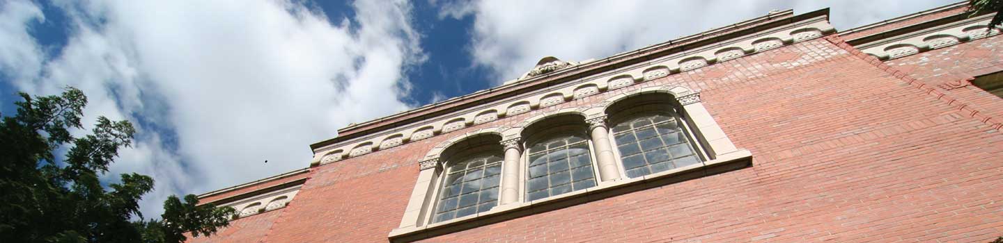 Skyward view of the brick west side of Chapman Hall