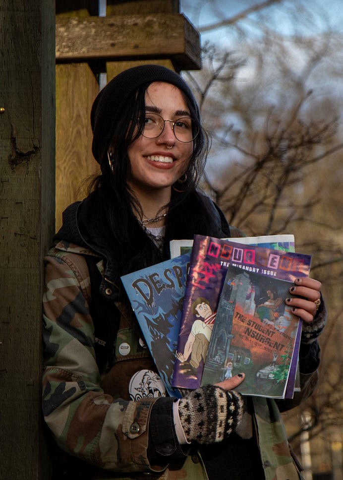 Jess Gladis holding magazines.