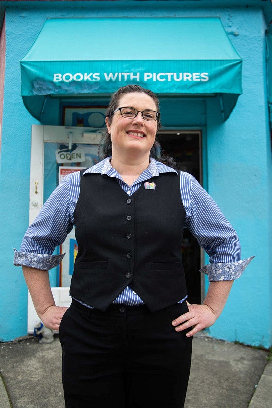 Katie Pryde standing before her bookstore, Books With Pictures
