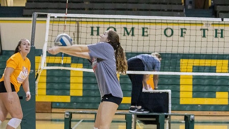 Jane Morgan serves a volleball.