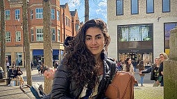 Raimy Khalife-Hamdan (2022) pauses in a busy street 