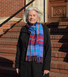 Genice Rabe stands in front of the stone and brick steps of Chapman Hall's west entrance.