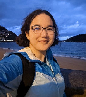 Emma Koontz on a beach at twilight.