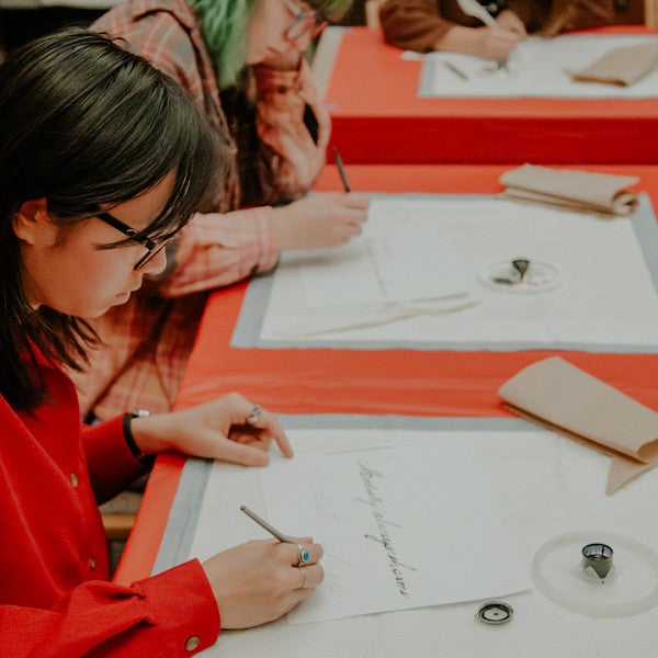 Lauren Jin practices calligraphy in last year's class, Book Love