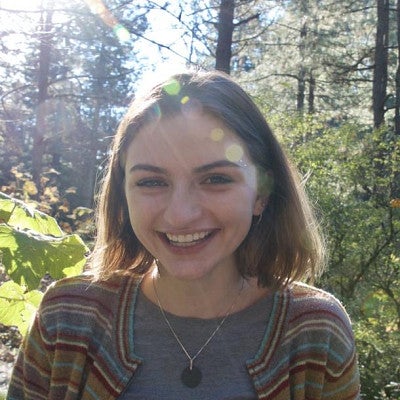 Mugshot of Julia Rehmann standing in a wooded area